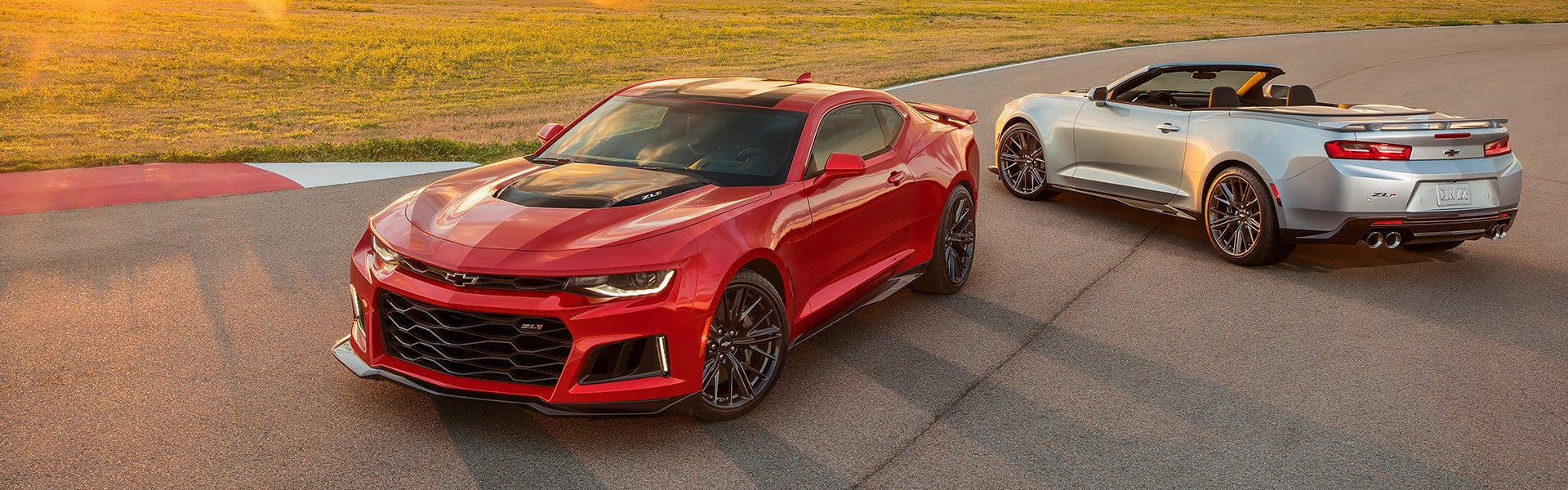 Red and silver sports cars parked