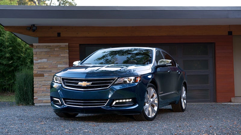 Chevrolet Impala parked outside house