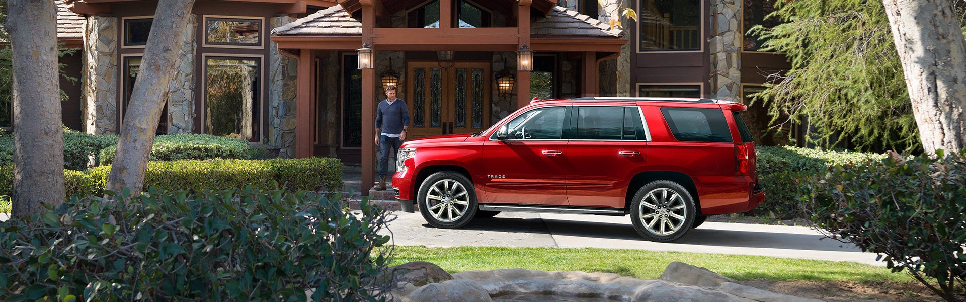 Red SUV parked in front home