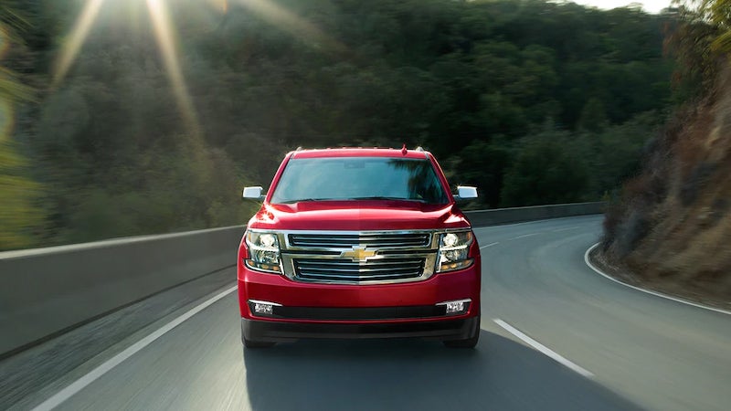 Red SUV driving on curve